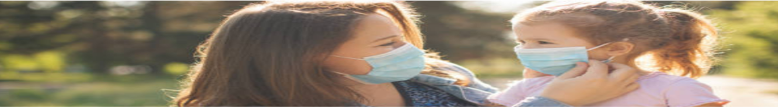 Mother putting mask on a child