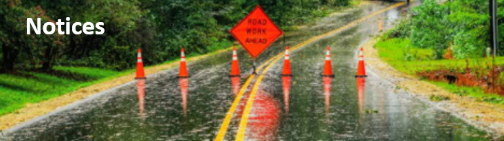 Road closed sign on a highway with the words notice