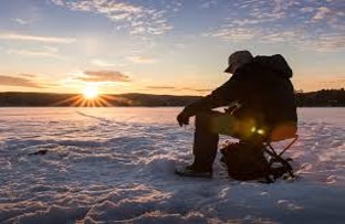 Man sitting on a bucket icefishing